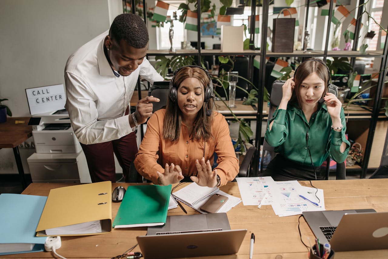 A diverse group of call center employees collaborating in a modern office setting with teamwork and technology.